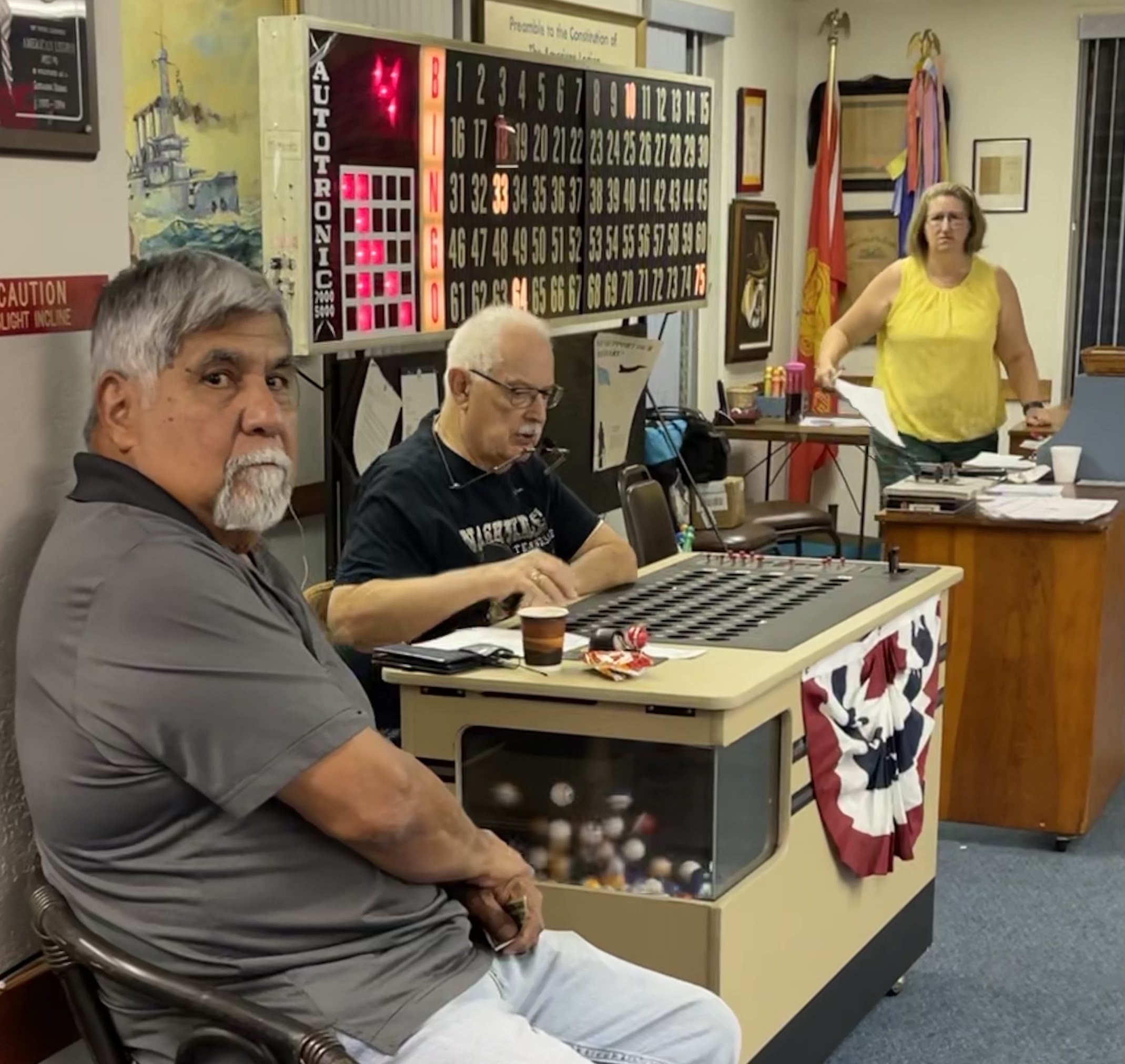 Bingo night at American Legion Post 6 with electronic bingo board and caller's table