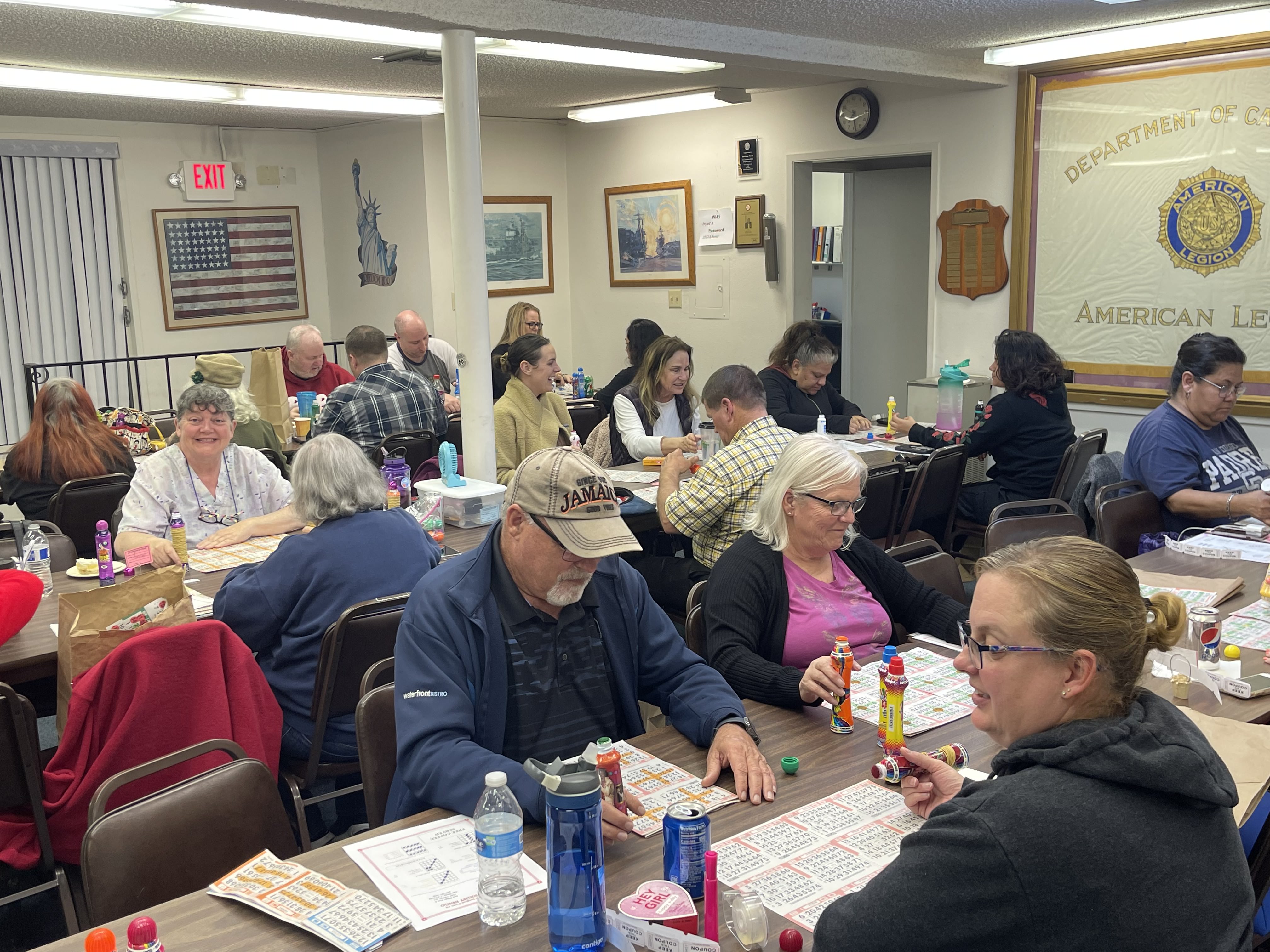 Full bingo hall at American Legion Post 6 with American flags and patriotic decorations