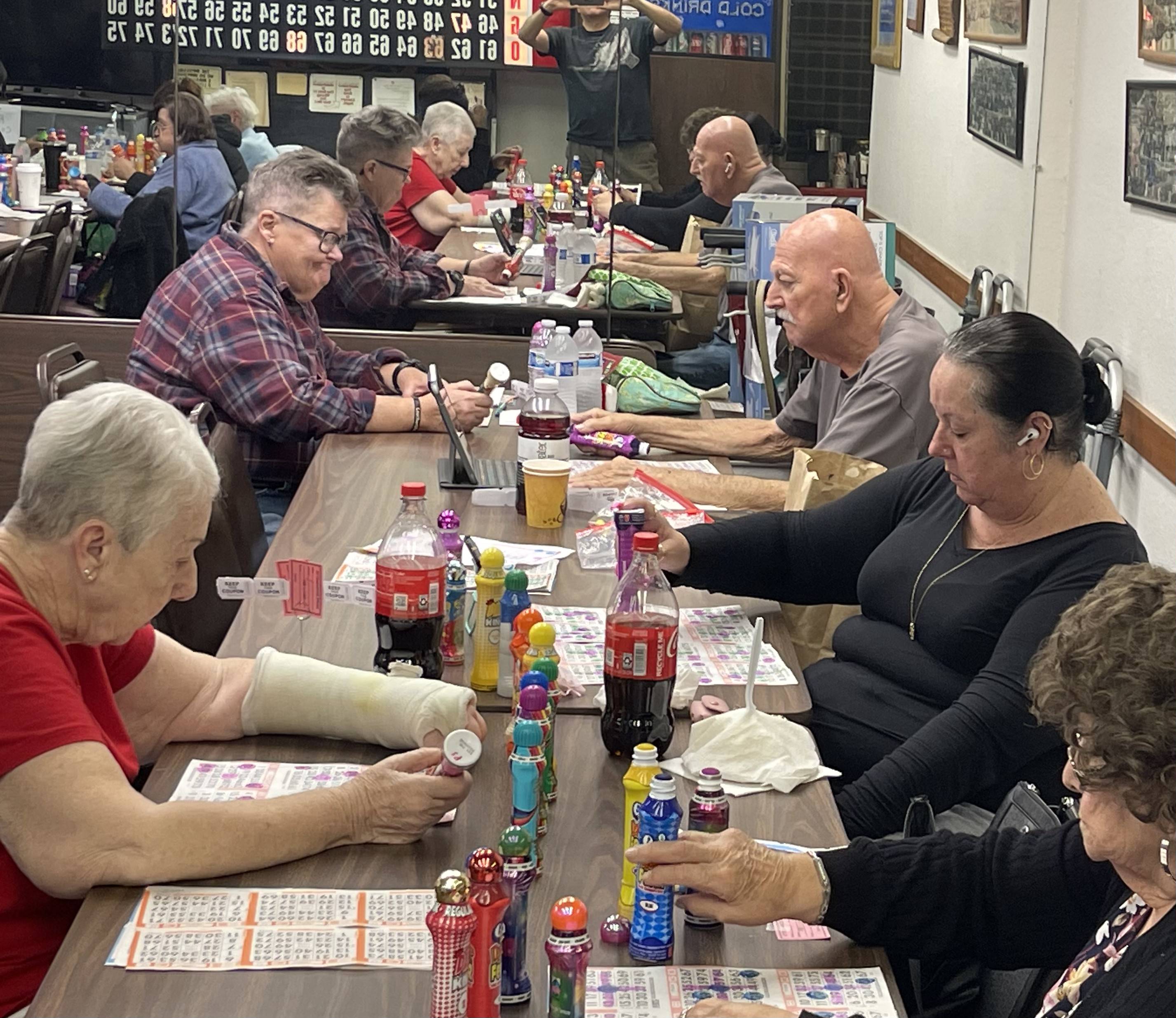 Close-up of bingo players focused on their cards during weekly bingo night at Post 6